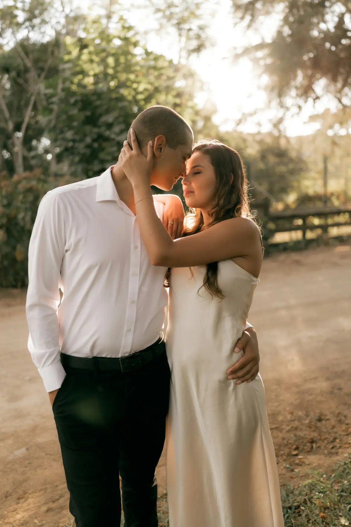A couple holding each other close outdoors