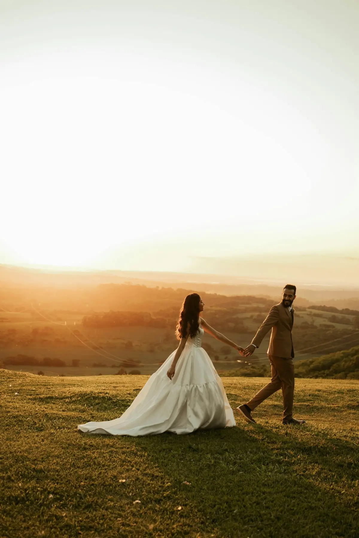 A couple walking hand in hand at golden hour